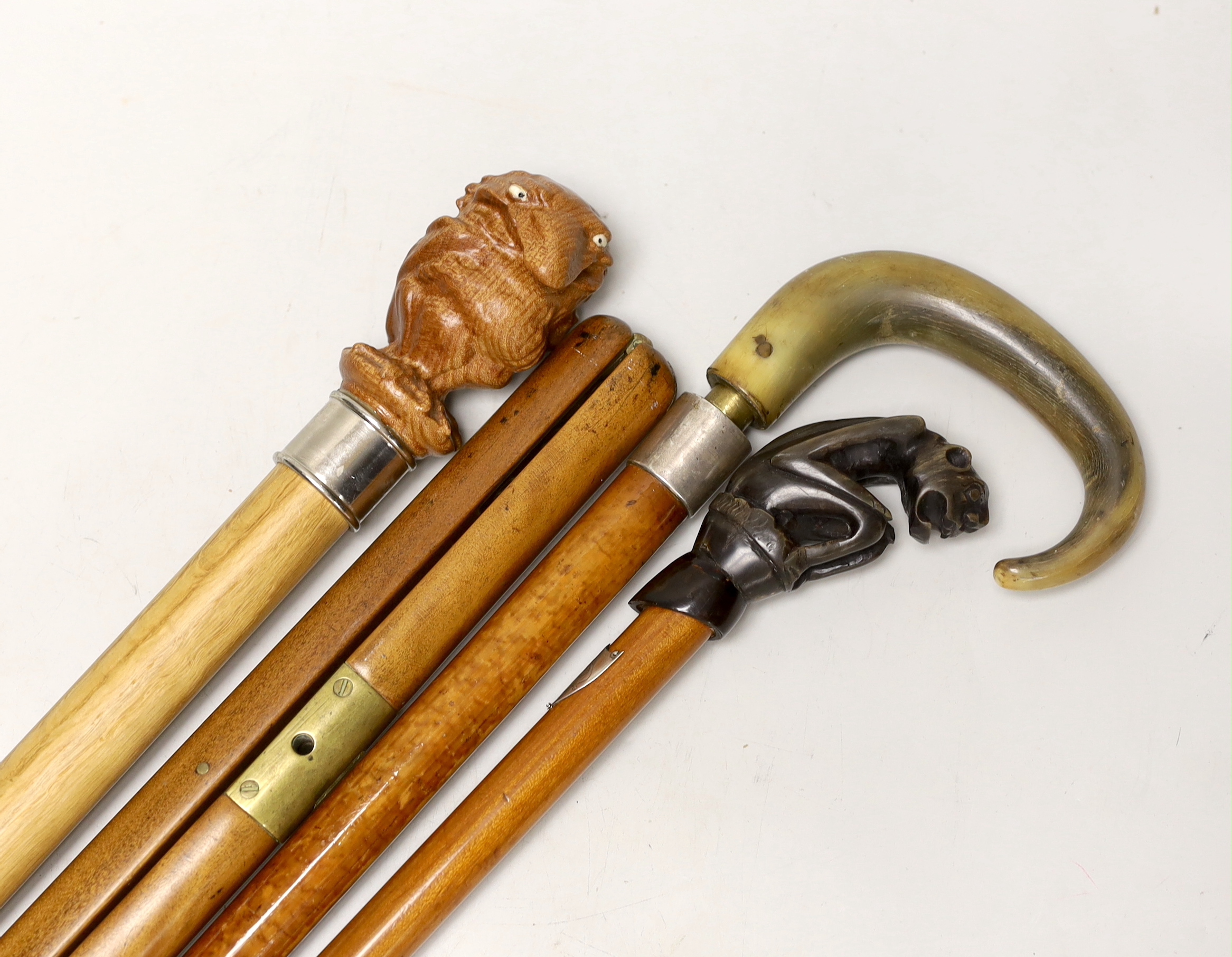 Four canes / walking sticks including a horse measuring stick and a military pace stick